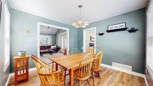 dining room with visible vents, baseboards, and light wood-style floors