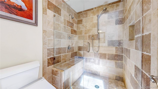 full bath with a shower stall and toilet