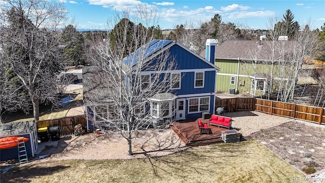 back of property featuring a patio, board and batten siding, and a fenced backyard