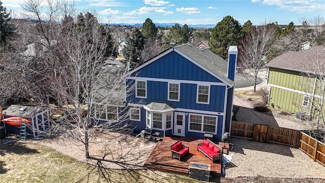 back of property with a patio area, board and batten siding, outdoor lounge area, and a fenced backyard