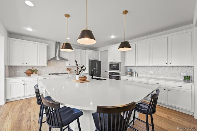 5078 S Quail St, Littleton, CO 80127 - kitchen with wall chimney range hood, appliances with stainless steel finishes, white cabinetry, and recessed lighting