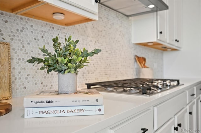 5078 S Quail St, Littleton, CO 80127 - kitchen featuring exhaust hood, tasteful backsplash, stainless steel gas stovetop, and white cabinets