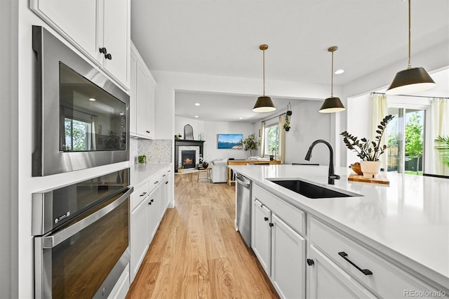 5078 S Quail St, Littleton, CO 80127 - kitchen with stainless steel appliances, light wood-type flooring, light countertops, white cabinets, and recessed lighting