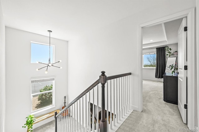 5078 S Quail St, Littleton, CO 80127 - hall with carpet, an upstairs landing, and a chandelier