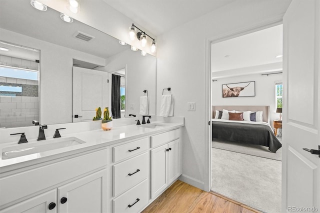 5078 S Quail St, Littleton, CO 80127 - ensuite bathroom with double vanity, wood finished floors, and a tile shower