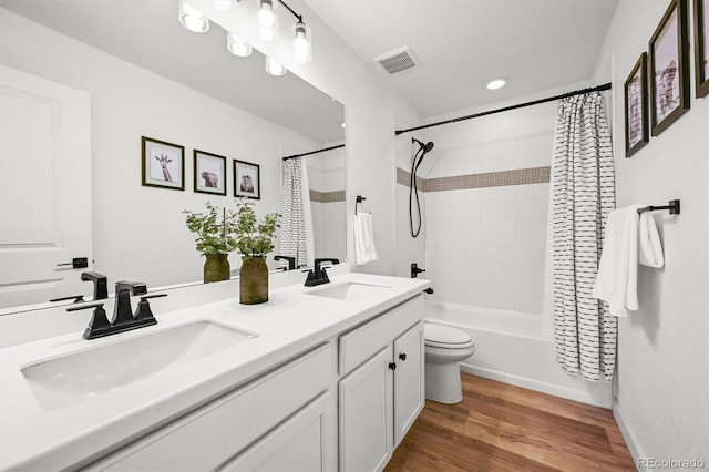 5078 S Quail St, Littleton, CO 80127 - bathroom featuring double vanity, shower / bath combination with curtain, wood finished floors, and recessed lighting