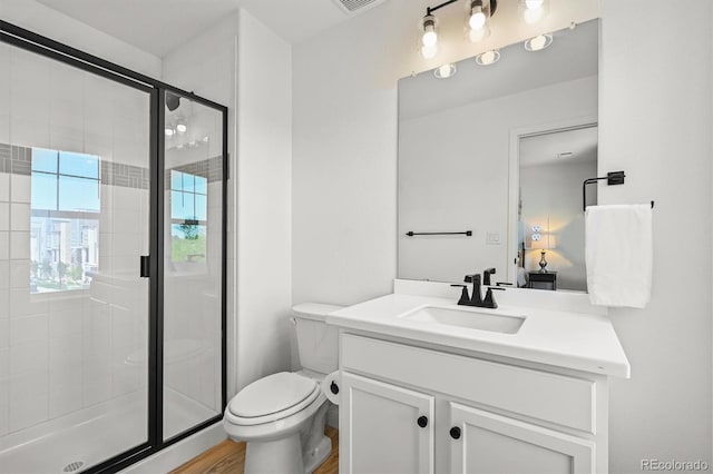 5078 S Quail St, Littleton, CO 80127 - full bath featuring vanity, a stall shower, and wood finished floors