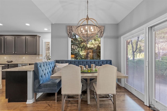 dining space featuring baseboards, a notable chandelier, recessed lighting, and wood finished floors