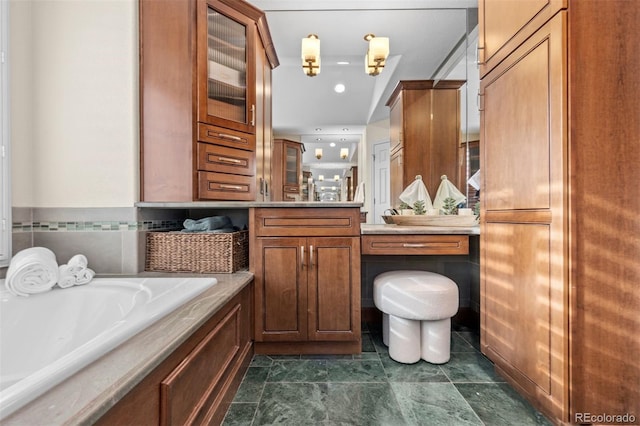 full bathroom with a garden tub and vanity