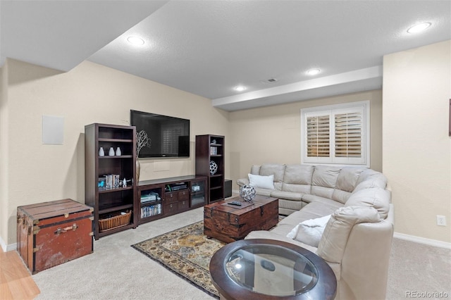 carpeted living area featuring visible vents, baseboards, and recessed lighting