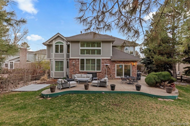 back of property featuring an outdoor hangout area, a tiled roof, brick siding, and a yard