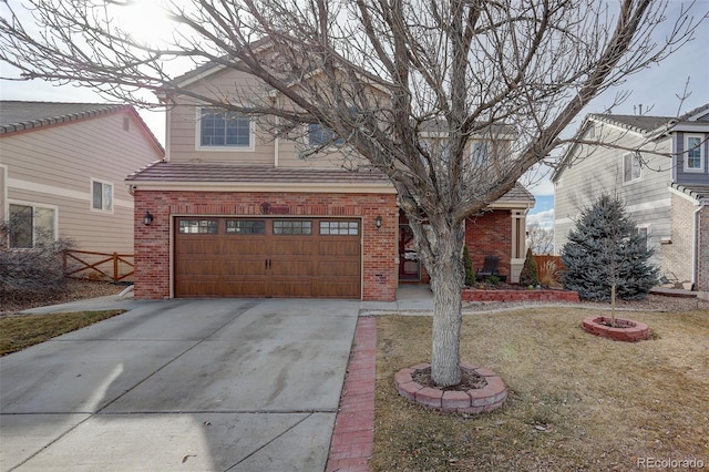 view of front of house with an attached garage, concrete driveway, and brick siding