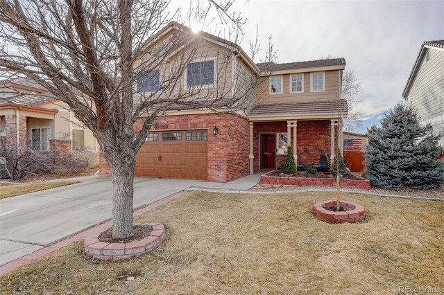 view of front of house with a garage, brick siding, driveway, and a front lawn