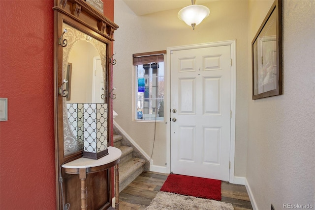 interior space featuring stairway, baseboards, and wood finished floors