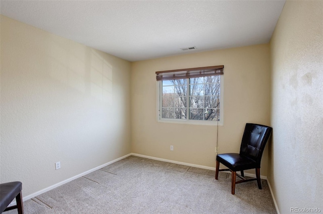 living area with a textured ceiling, a textured wall, carpet flooring, visible vents, and baseboards