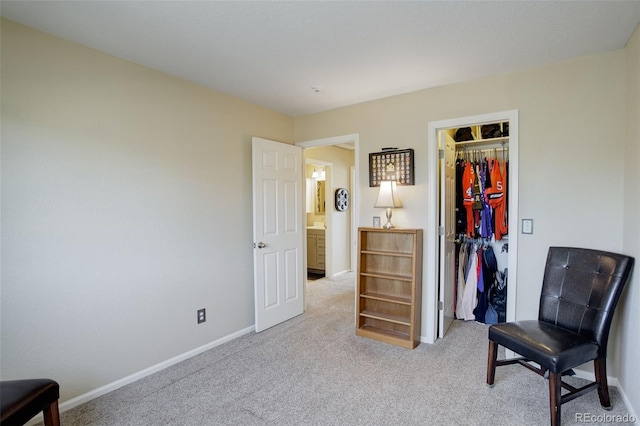 sitting room featuring carpet and baseboards