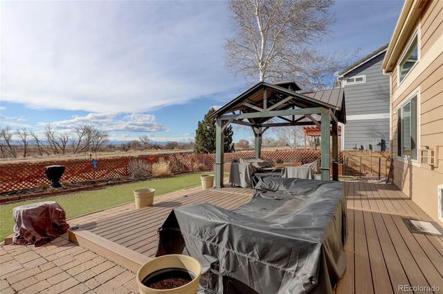 wooden deck featuring fence and a gazebo