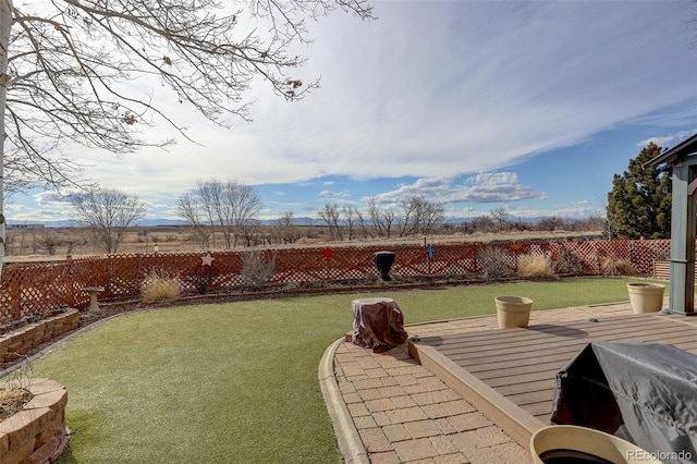 view of yard featuring a fenced backyard and a deck