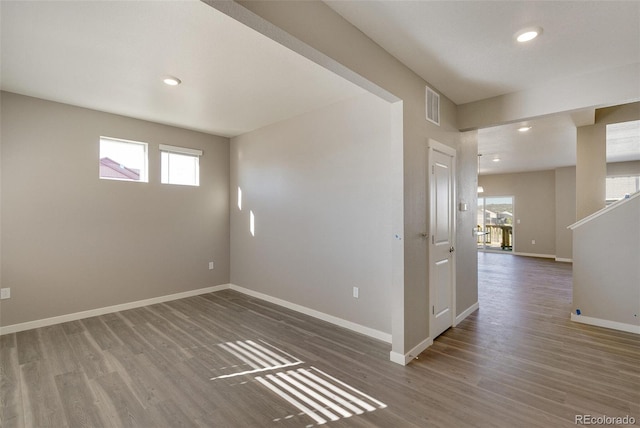 unfurnished room featuring dark hardwood / wood-style flooring