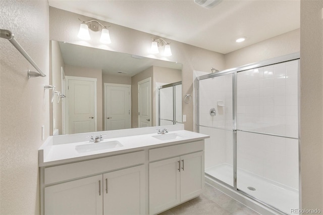 bathroom with vanity, an enclosed shower, and tile patterned flooring