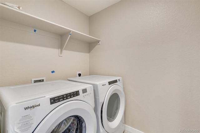 clothes washing area featuring washer and dryer