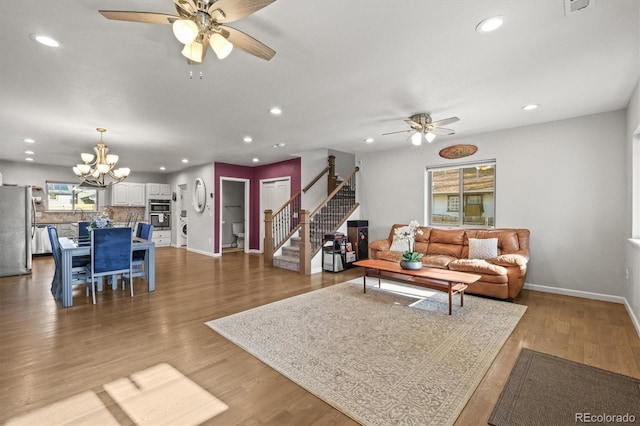 4942 Grove St, Denver, CO 80221 - living area with stairway, ceiling fan with notable chandelier, baseboards, and recessed lighting