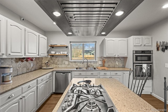 4942 Grove St, Denver, CO 80221 - kitchen featuring a sink, dark wood-style flooring, stainless steel appliances, and white cabinets
