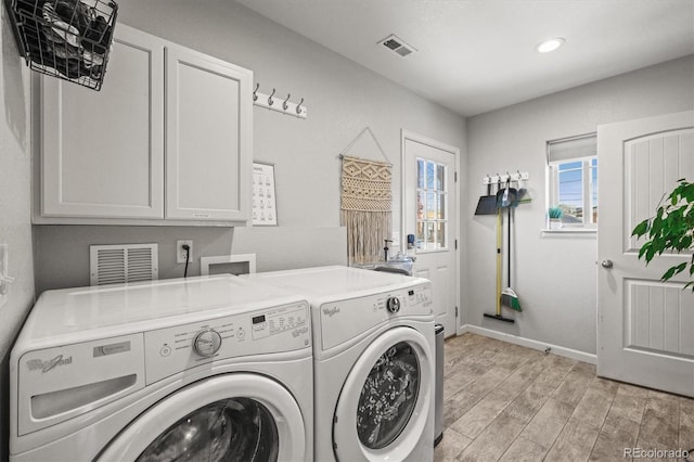 4942 Grove St, Denver, CO 80221 - washroom with baseboards, light wood finished floors, visible vents, washer and clothes dryer, and cabinet space