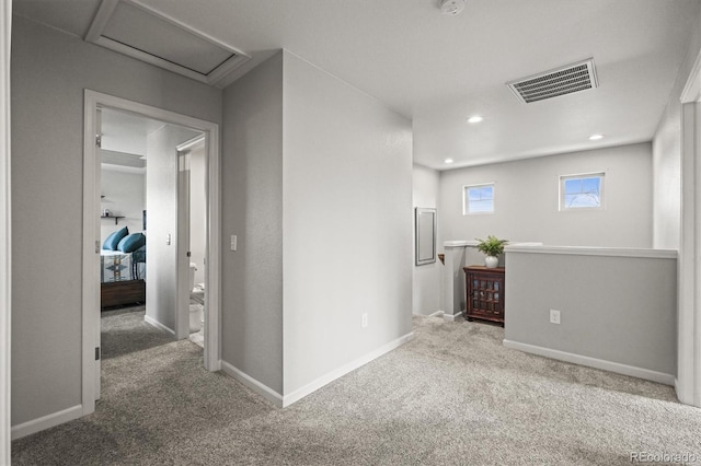 4942 Grove St, Denver, CO 80221 - corridor with attic access, an upstairs landing, visible vents, carpet flooring, and baseboards