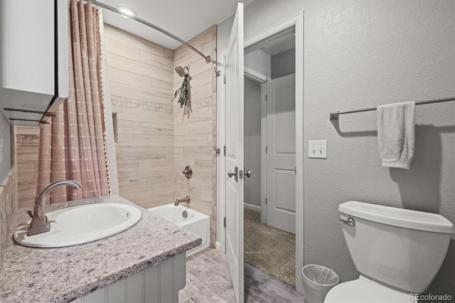 4942 Grove St, Denver, CO 80221 - full bath featuring toilet, shower / tub combo, vanity, and a textured wall