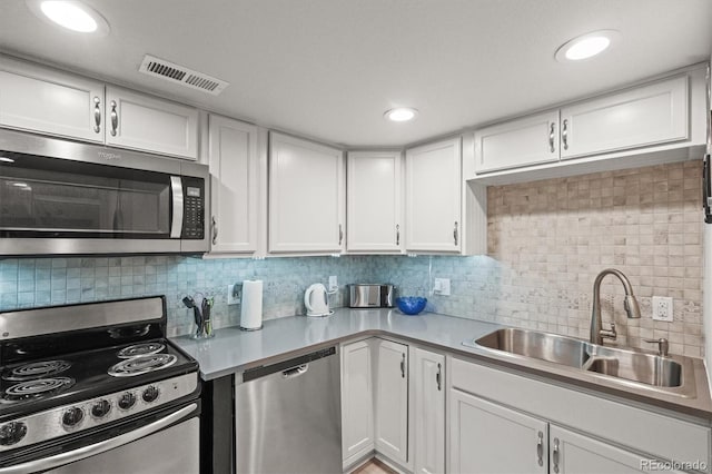 4942 Grove St, Denver, CO 80221 - kitchen featuring a sink, stainless steel appliances, tasteful backsplash, and light countertops