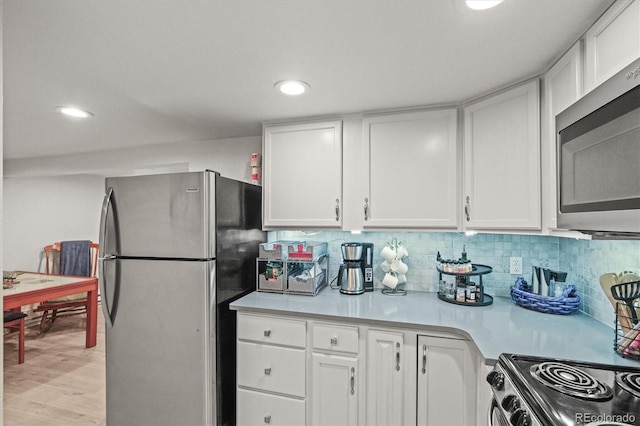 4942 Grove St, Denver, CO 80221 - kitchen with recessed lighting, white cabinets, and appliances with stainless steel finishes