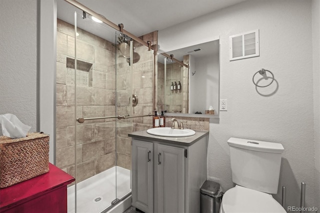 4942 Grove St, Denver, CO 80221 - bathroom with a shower stall, toilet, vanity, and visible vents