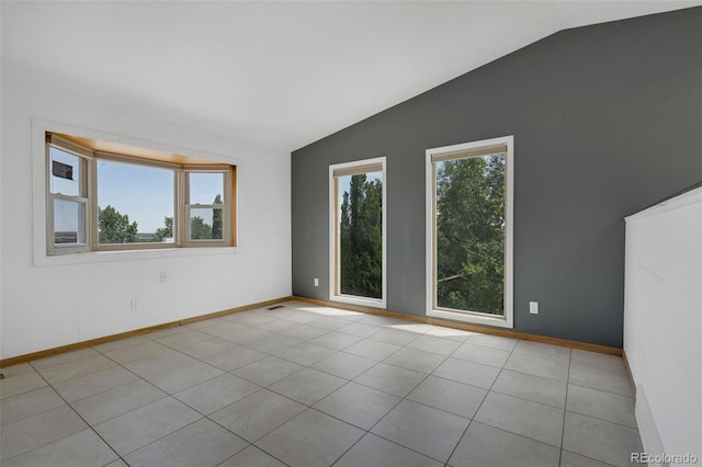 18 Clover Cir, Colorado Springs, CO 80906 - tiled empty room featuring lofted ceiling and baseboards