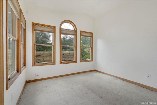 18 Clover Cir, Colorado Springs, CO 80906 - carpeted empty room with lofted ceiling and baseboards