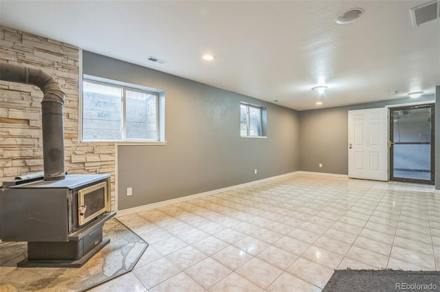 18 Clover Cir, Colorado Springs, CO 80906 - unfurnished living room featuring a wood stove and light tile patterned flooring