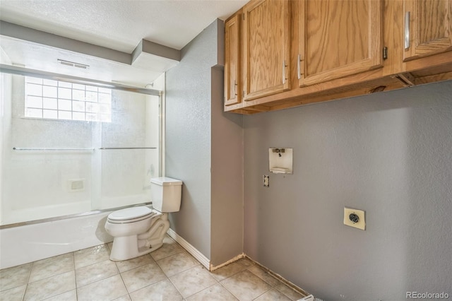 18 Clover Cir, Colorado Springs, CO 80906 - full bathroom with shower / bath combination with glass door, tile patterned flooring, a textured wall, and a textured ceiling