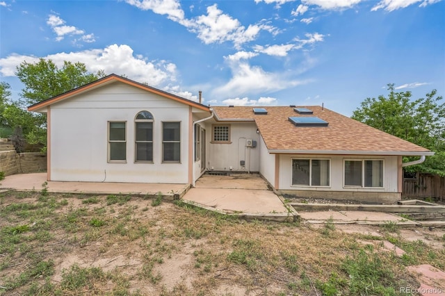 18 Clover Cir, Colorado Springs, CO 80906 - rear view of property featuring a patio area, solar panels, and roof with shingles