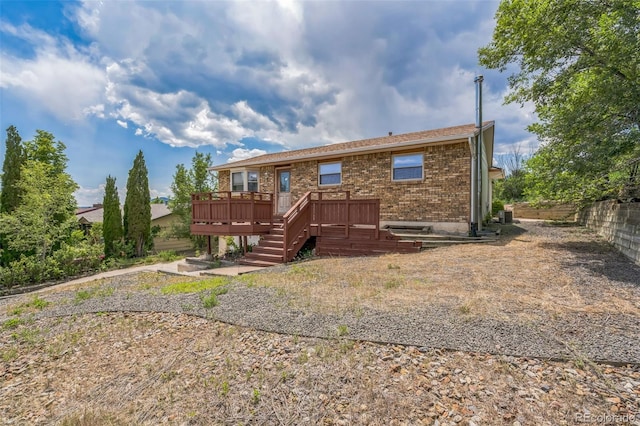 18 Clover Cir, Colorado Springs, CO 80906 - rear view of property with a wooden deck, brick siding, and stairway