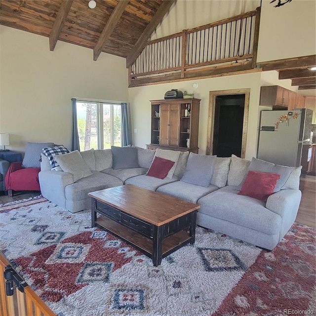 1034 Van Fossan Ln, Fort Garland, CO 81133 - living area featuring high vaulted ceiling, wooden ceiling with exposed beams, and wood finished floors