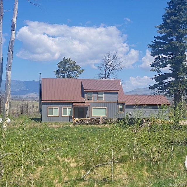 1034 Van Fossan Ln, Fort Garland, CO 81133 - back of property with metal roof, a mountain view, and board and batten siding