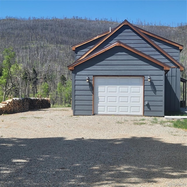 1034 Van Fossan Ln, Fort Garland, CO 81133 - garage with dirt driveway and a forest view