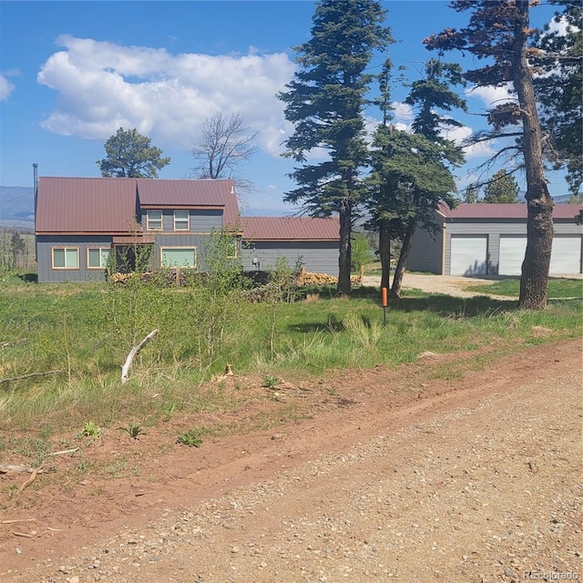 1034 Van Fossan Ln, Fort Garland, CO 81133 - rear view of house featuring metal roof and a garage