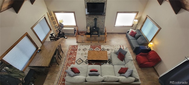 1034 Van Fossan Ln, Fort Garland, CO 81133 - living area with a wood stove, baseboards, and a towering ceiling