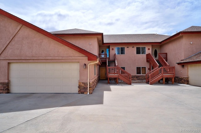 121 M And M Ln Unit 6C, Salida, CO 81201 - view of front of property featuring stone siding, concrete driveway, stucco siding, and stairs