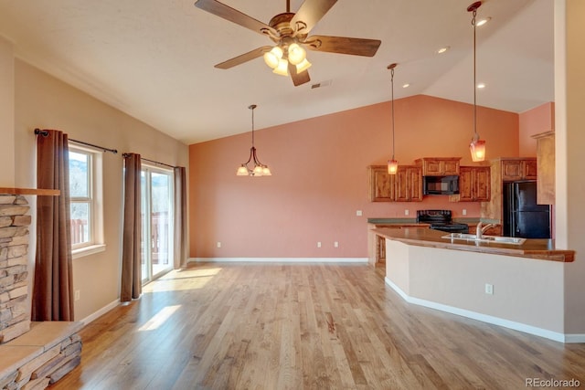 121 M And M Ln Unit 6C, Salida, CO 81201 - kitchen featuring a sink, decorative light fixtures, light wood-type flooring, black appliances, and brown cabinetry