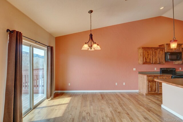 121 M And M Ln Unit 6C, Salida, CO 81201 - kitchen with brown cabinets, lofted ceiling, light wood-type flooring, black appliances, and an inviting chandelier