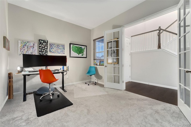 carpeted office space featuring lofted ceiling and french doors