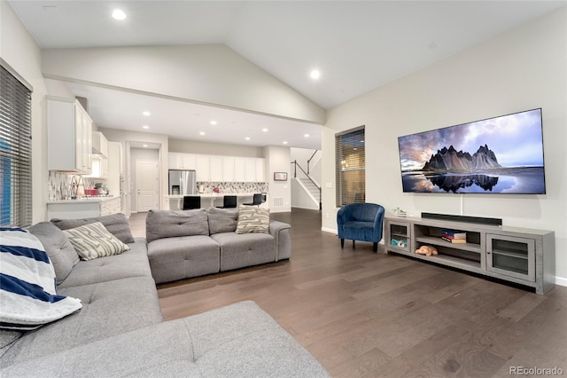 living room featuring sink, vaulted ceiling, and dark hardwood / wood-style floors