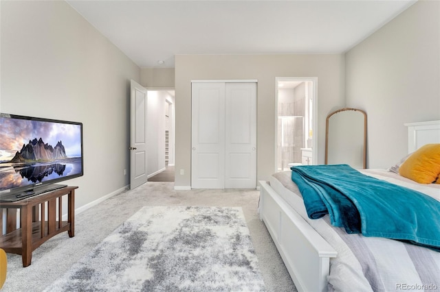 carpeted bedroom featuring ensuite bath and a closet